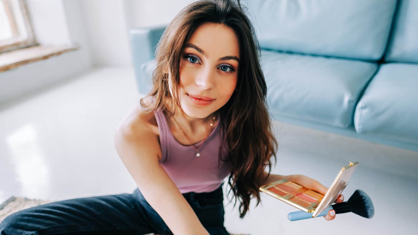 Woman spending time with herself, doing makeup.