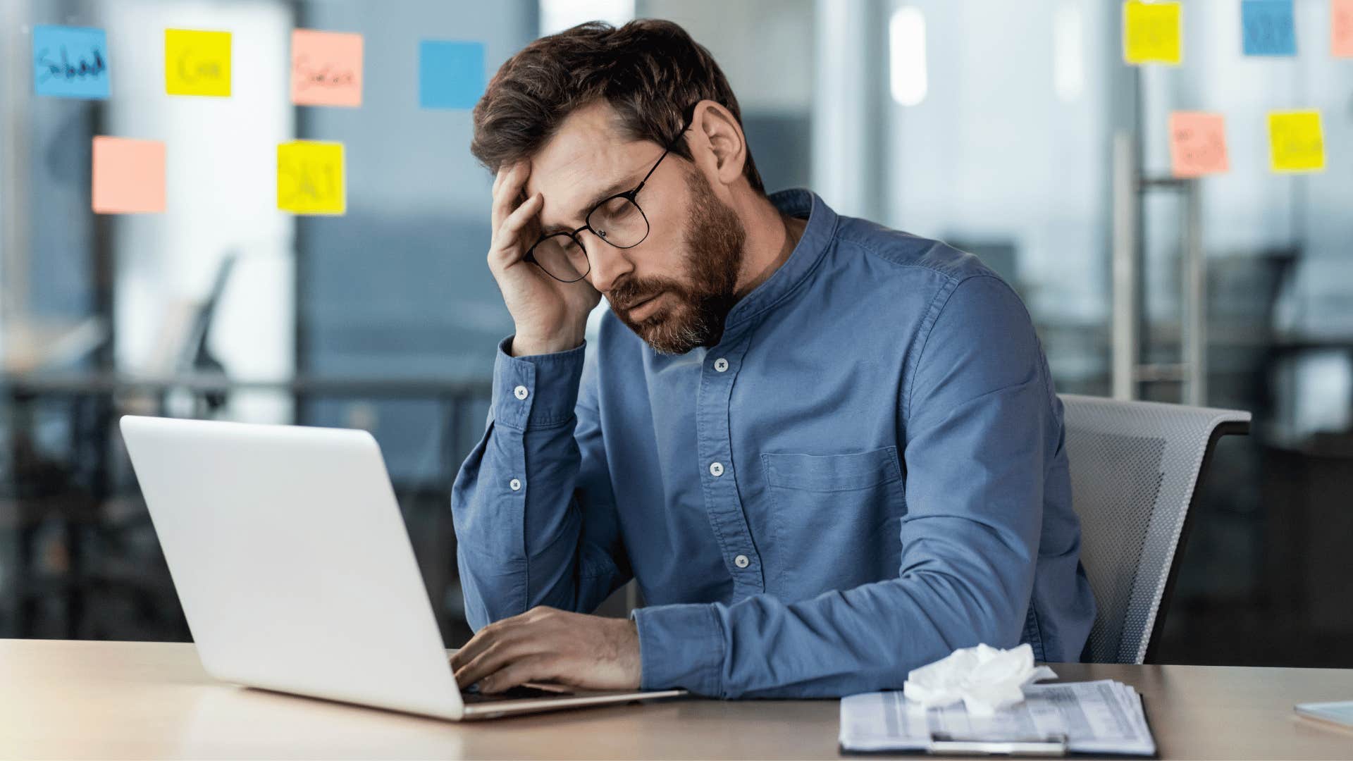 man looking at laptop tired of limited job opportunities