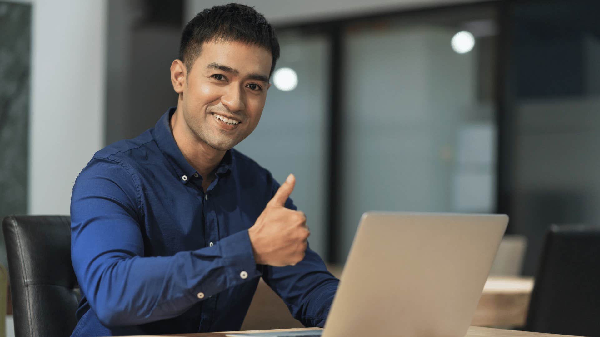 man giving a thumbs up while smiling 