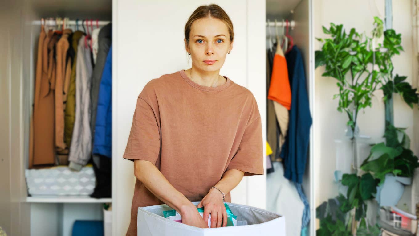 Woman working on tidying her home. 