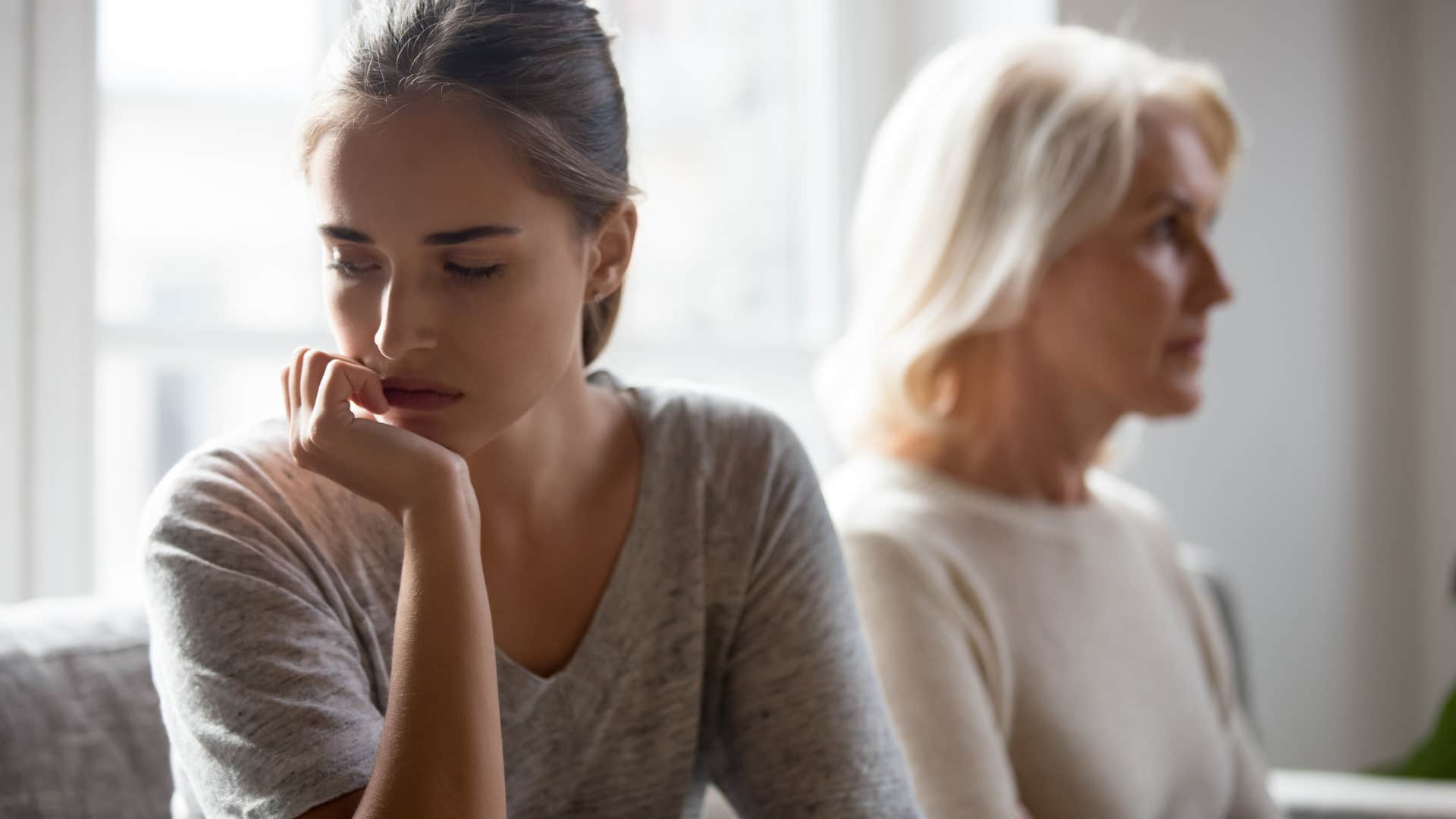 Adult daughter looking annoyed in front of her mother.