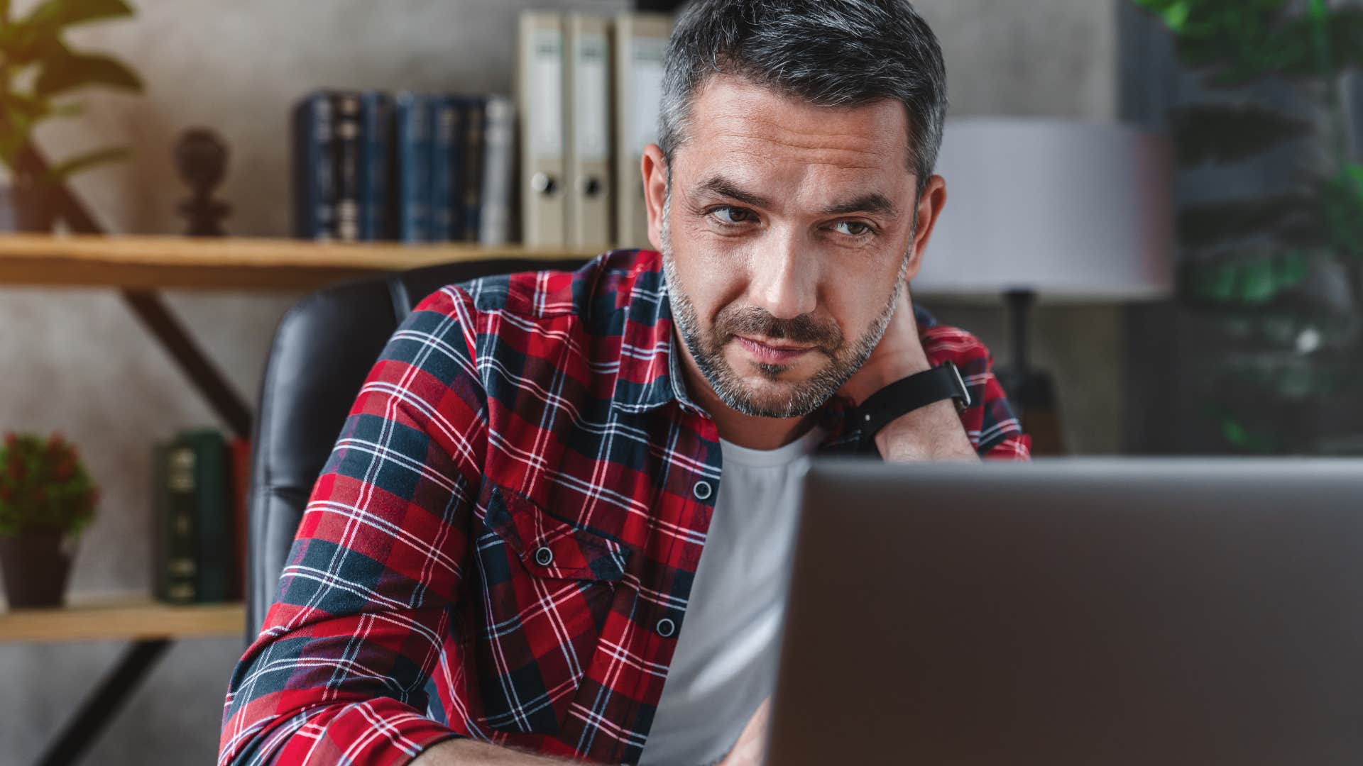 Man looking frustrated staring at his laptop.