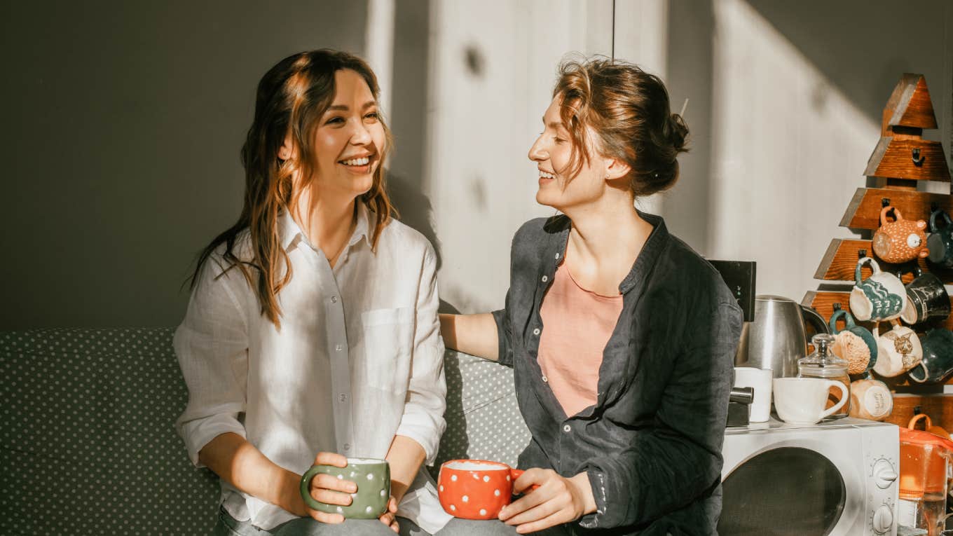 two women talking and drinking tea together