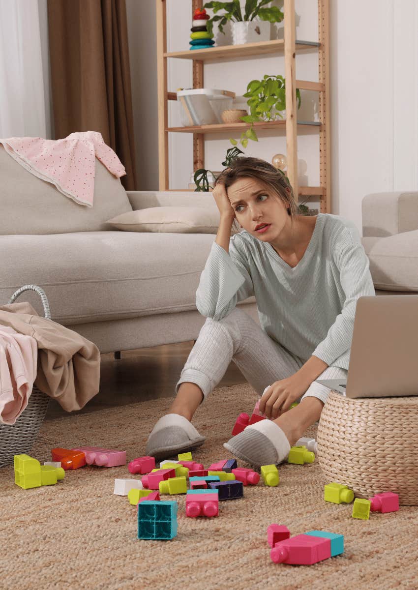 tired mom surrounded by toys