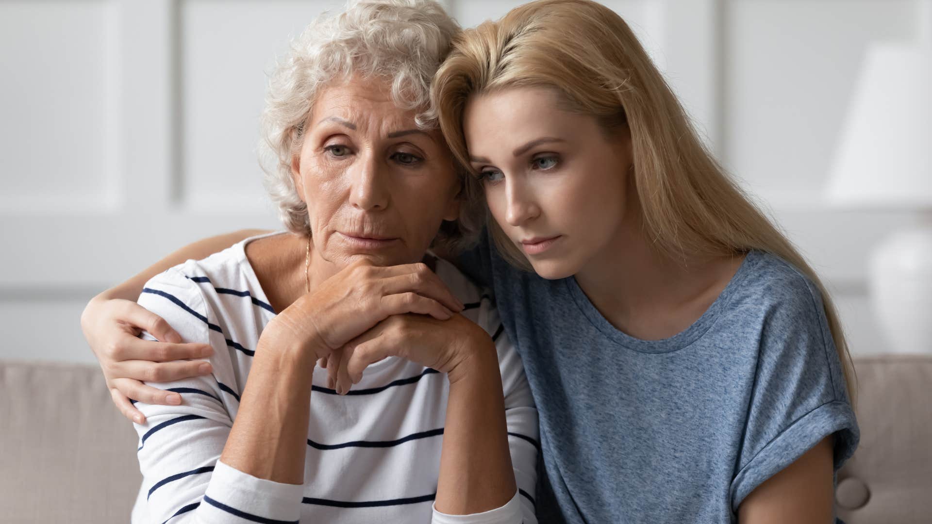 Adult daughter hugging her older mother.