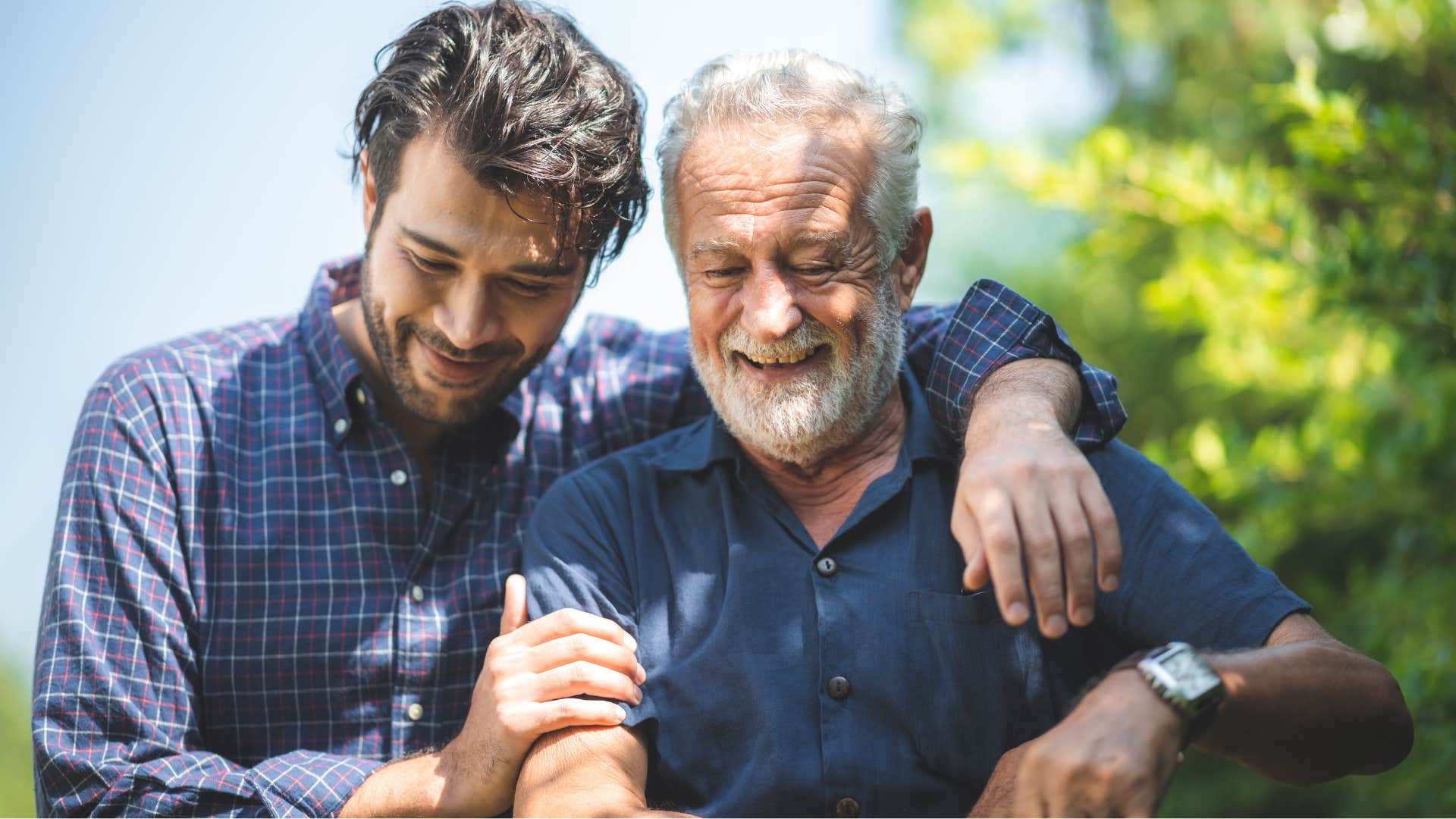 Dad hugging his adult son and walking outside.