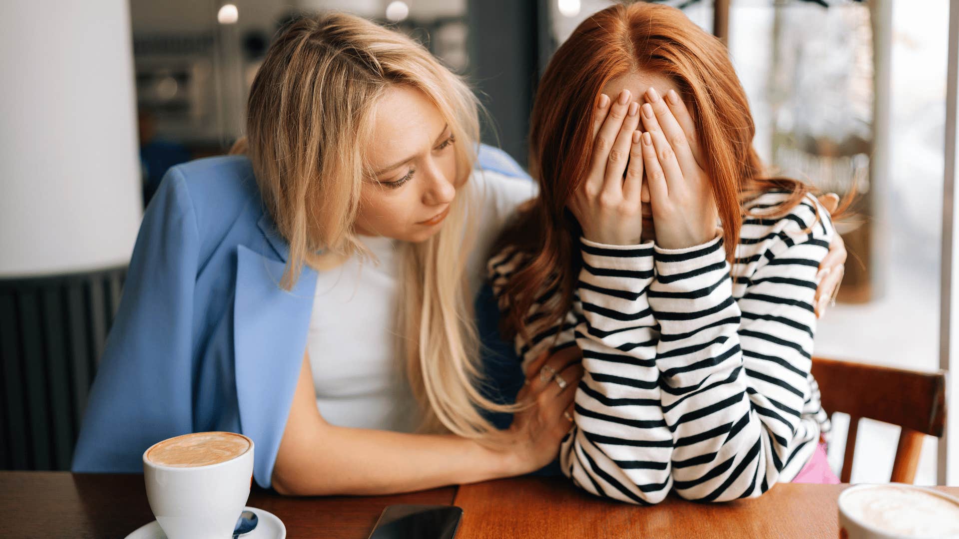 woman comforting crying friend