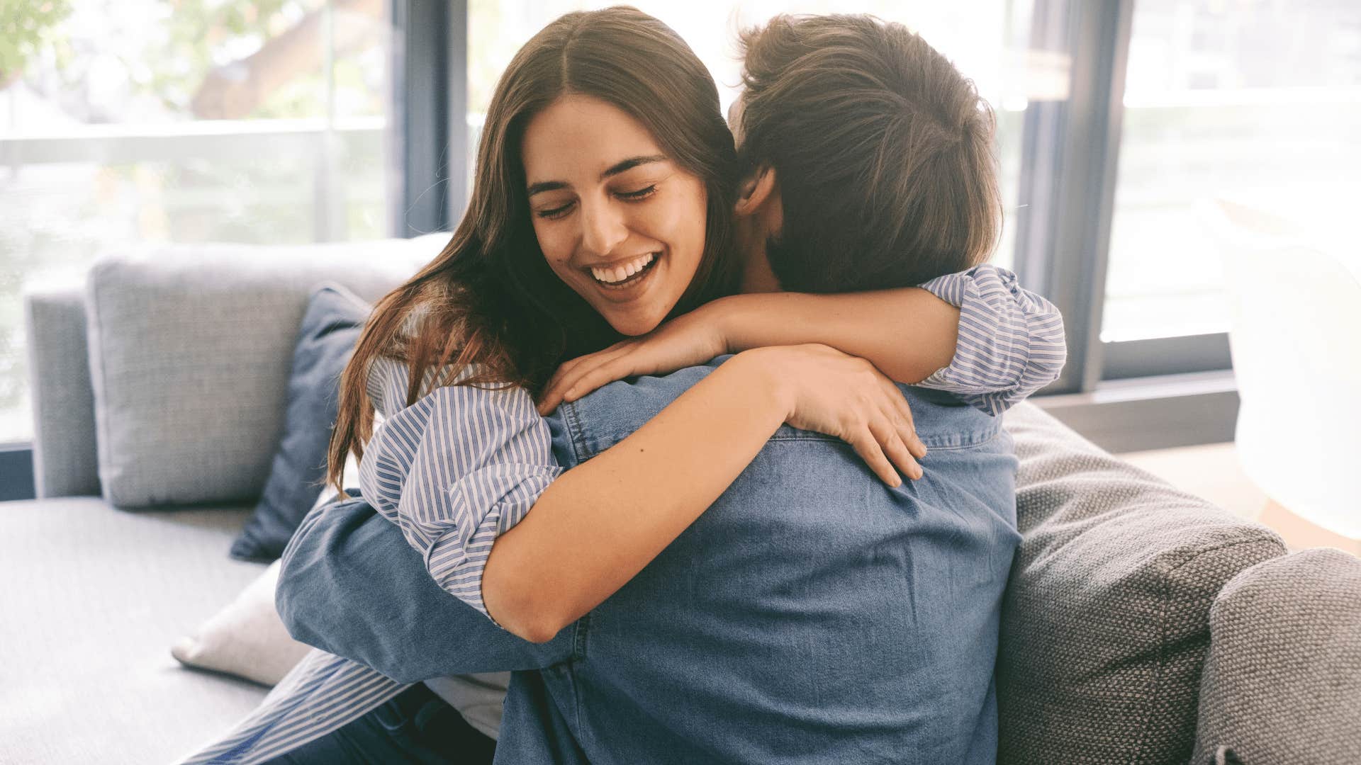 man and woman hugging on couch