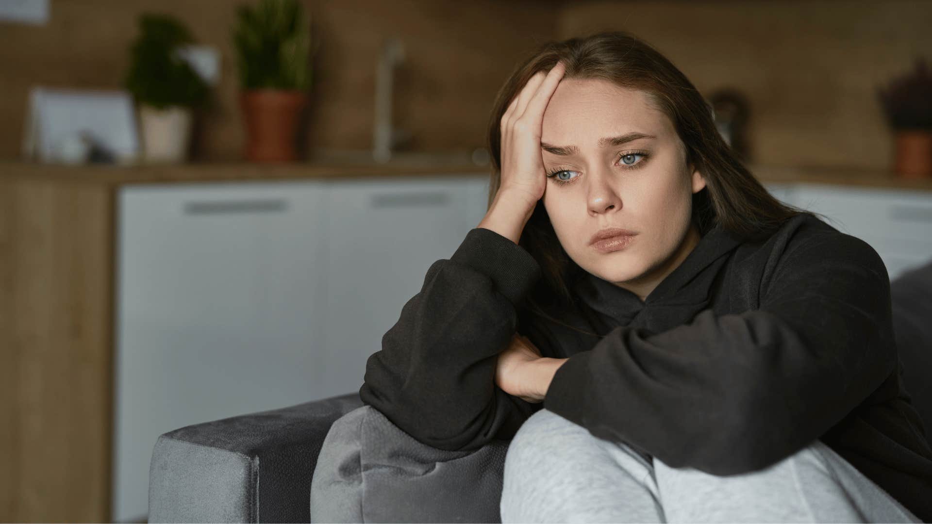 sad woman on couch