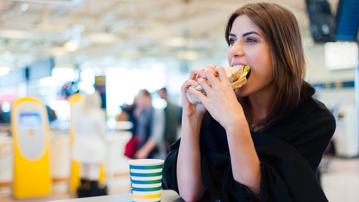 Traveler eating a sandwich in the airport