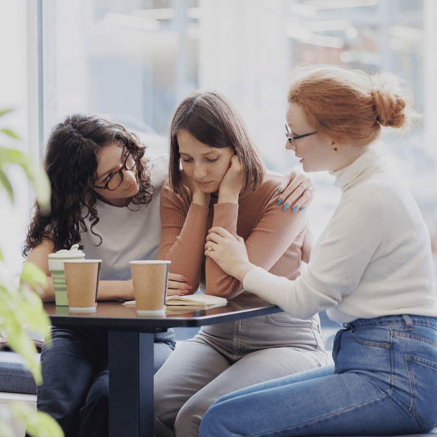 two friends comforting third friend