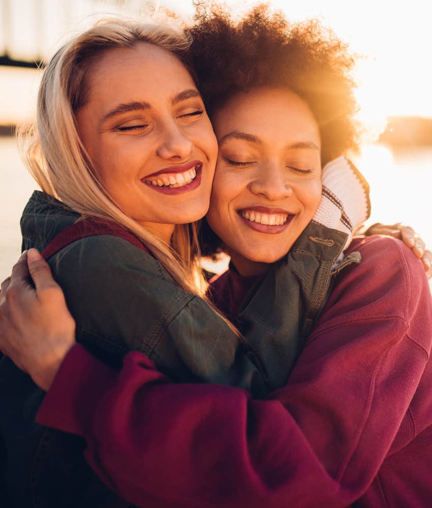 two happy women hugging