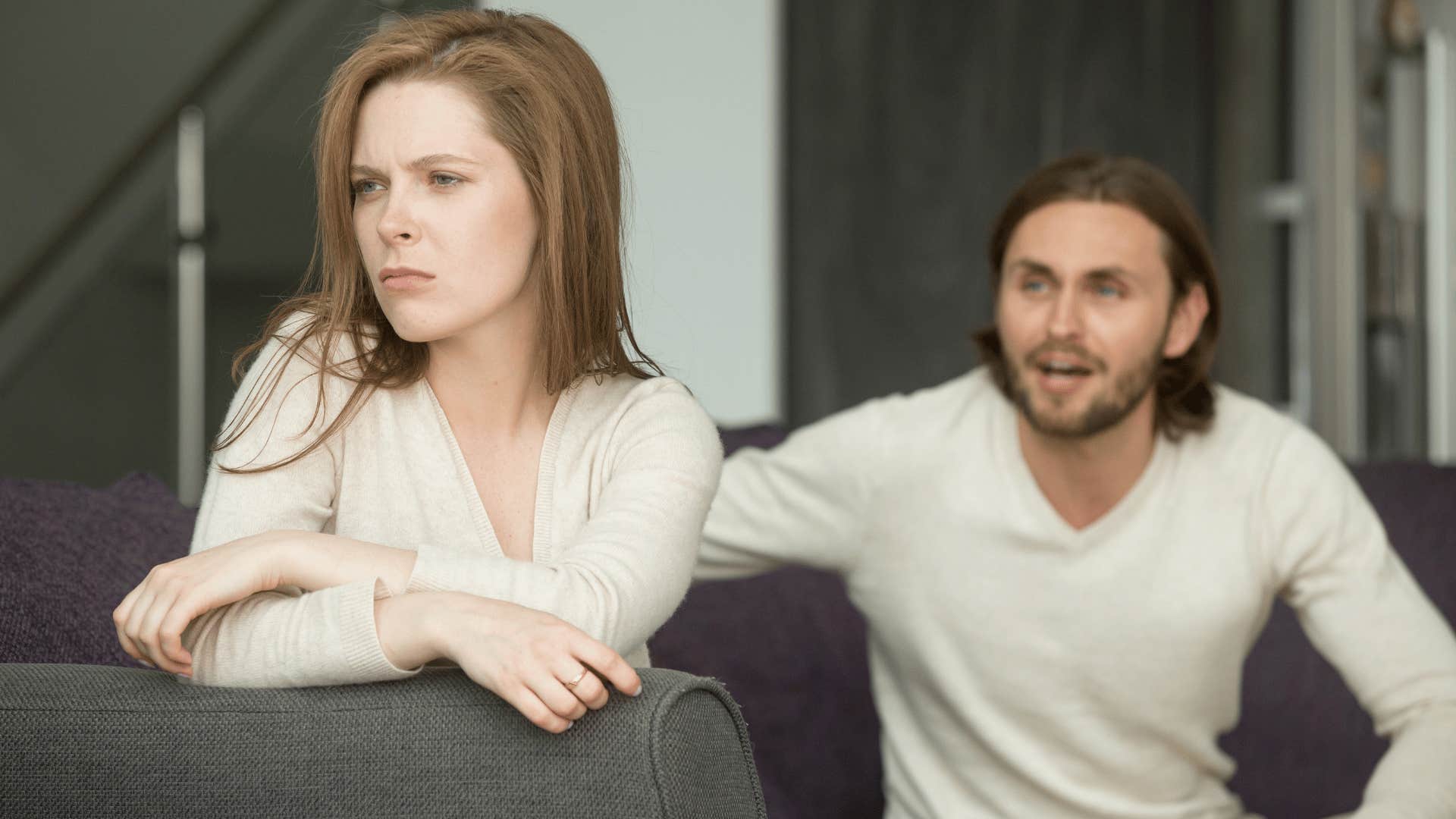 woman ignoring man on couch