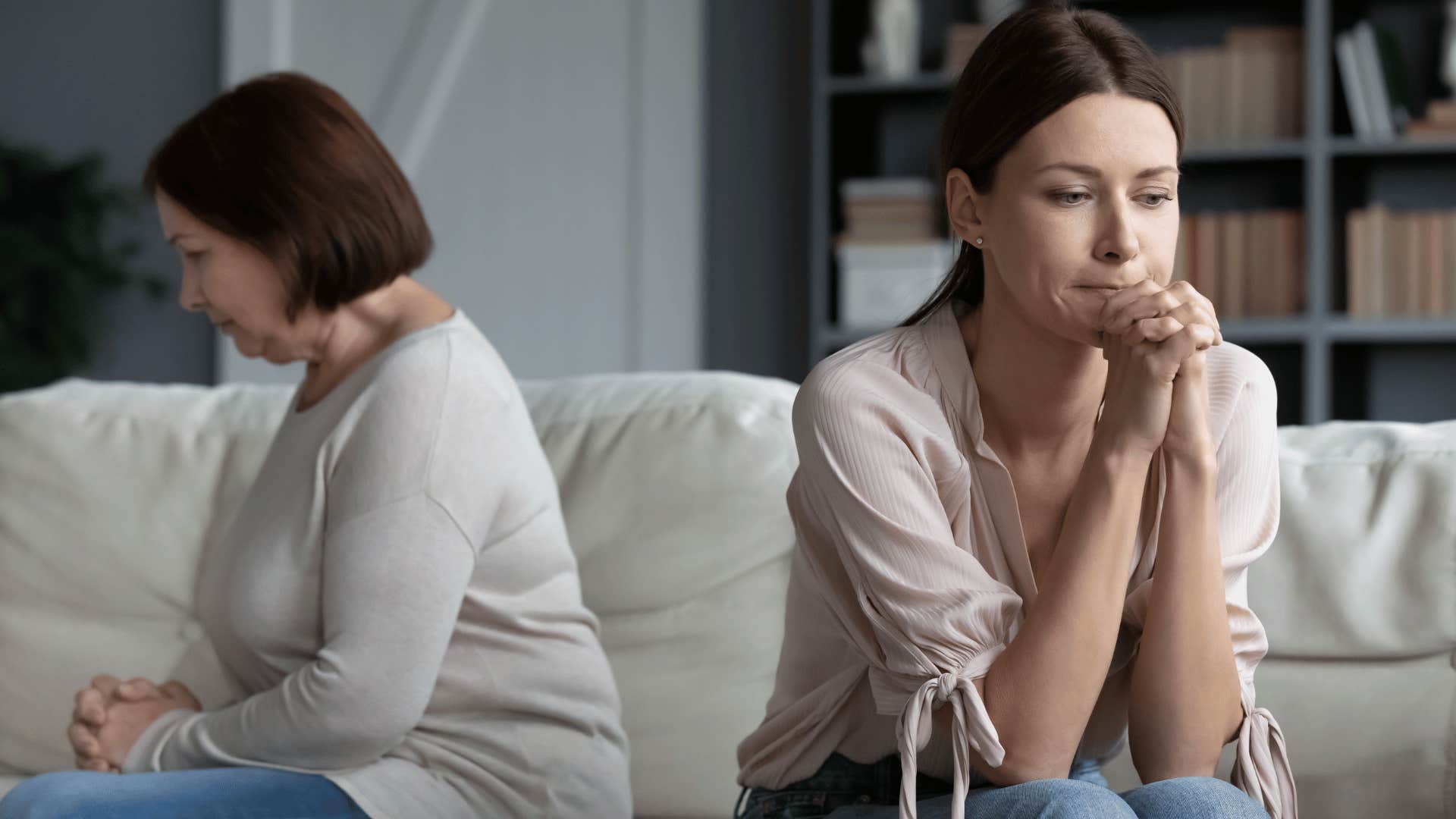 two women upset and turned away from each other