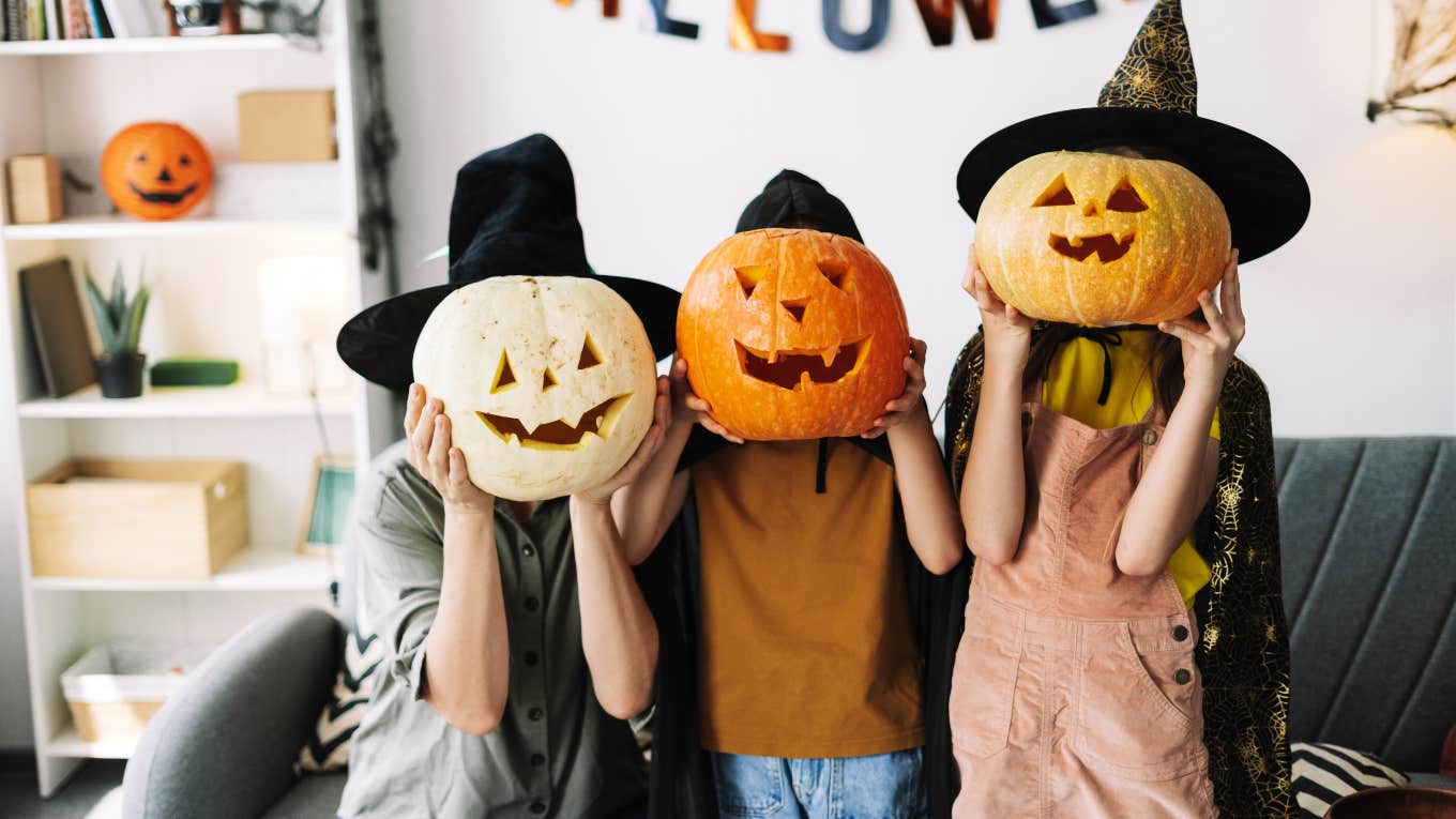 family with witch hats and jack-o-lanterns over their faces