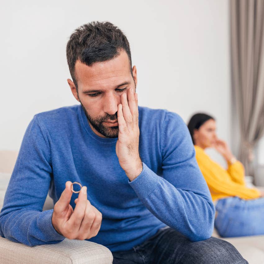 upset man looking down at his wedding ring