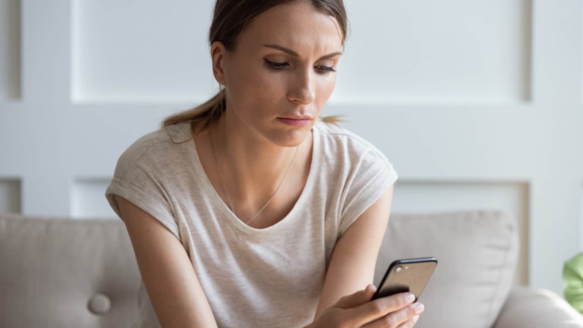 Upset woman looking at her cell phone. 