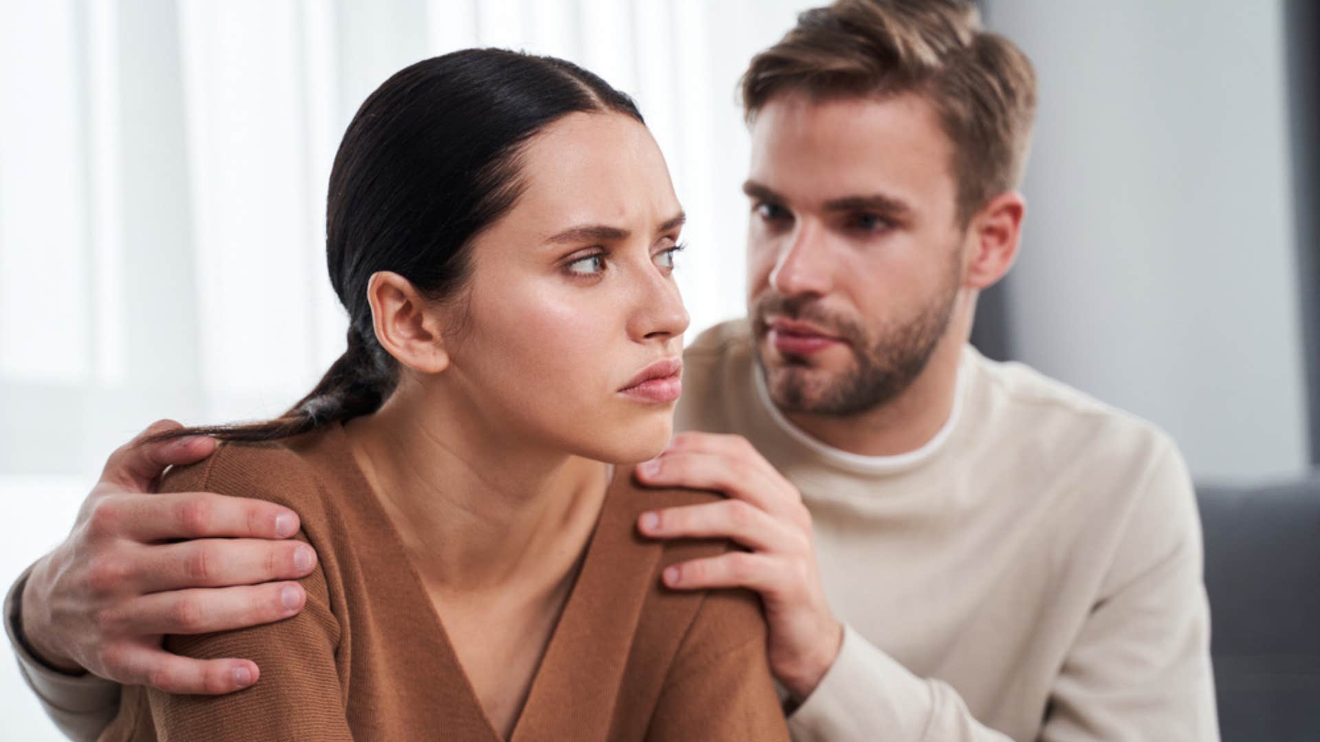 Woman being comforted by her boyfriend. 