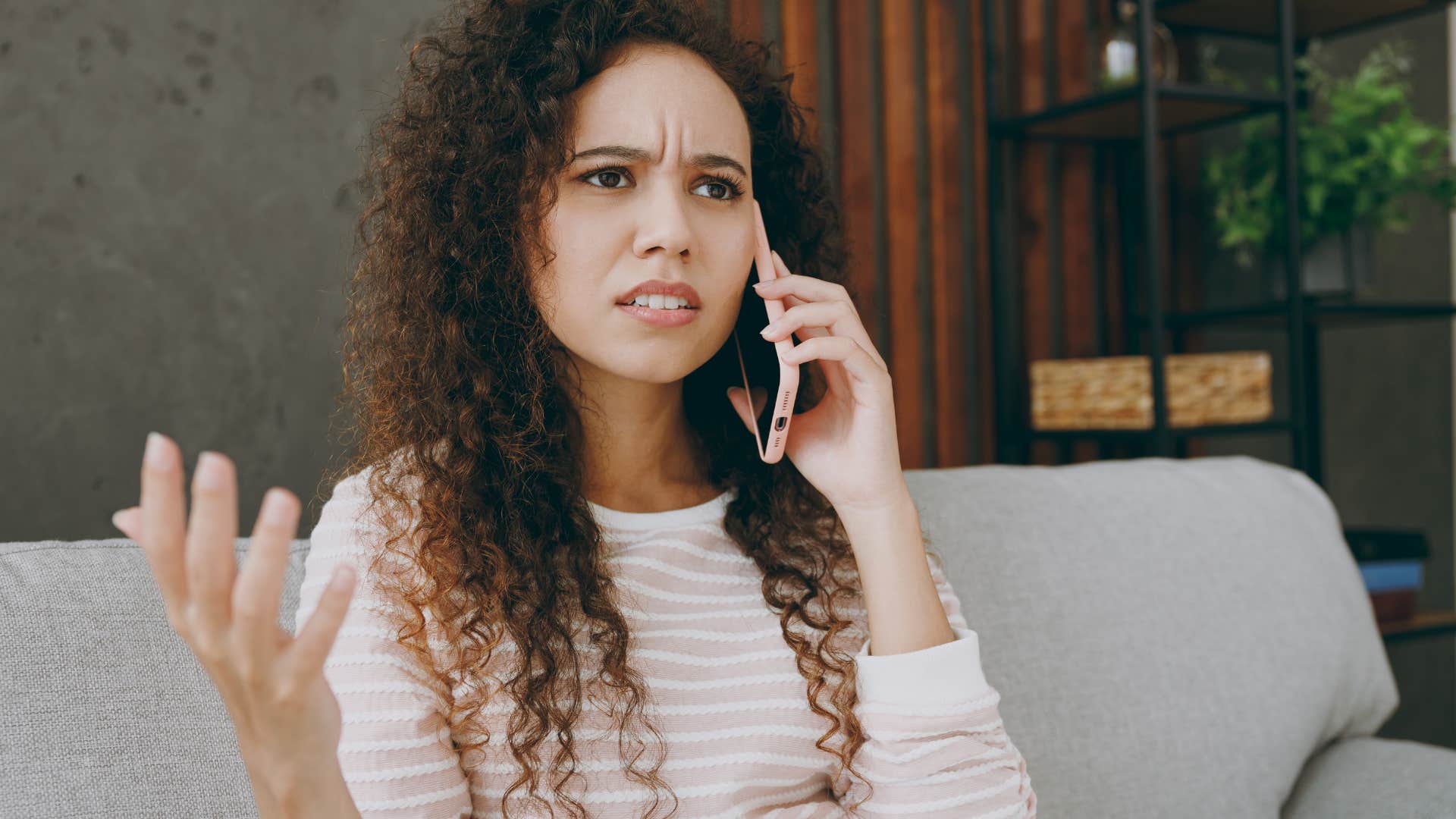 Woman looking upset while talking on the phone