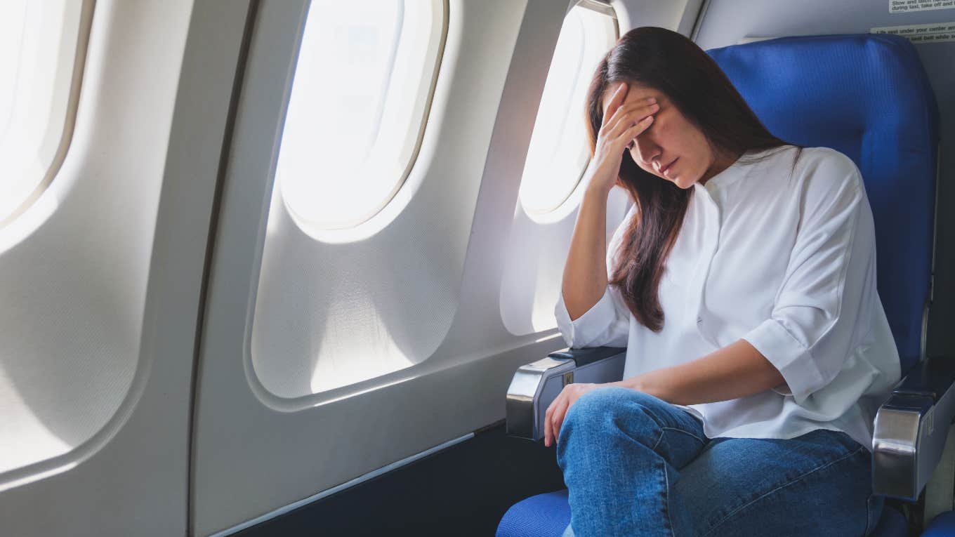 Sad woman on airplane