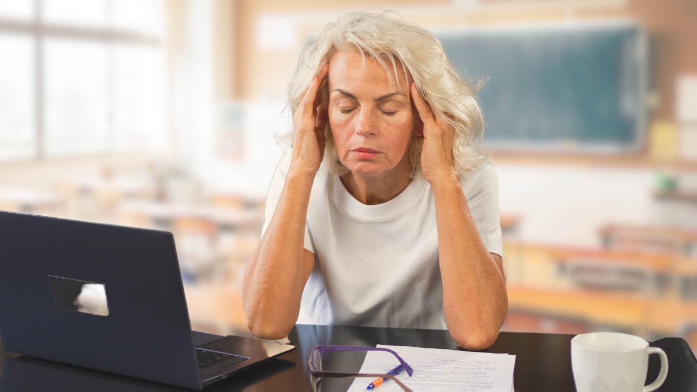 Veteran teacher looking exhausted thinking about students' feelings.