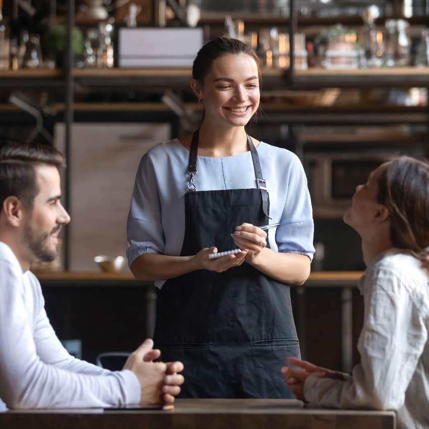 Waitress taking customers' orders