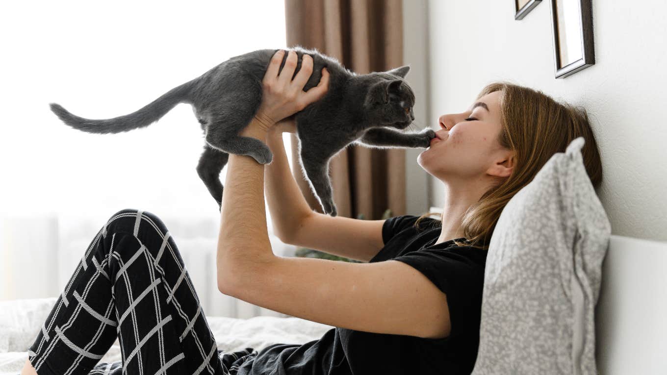 Cat putting their paw on their owner