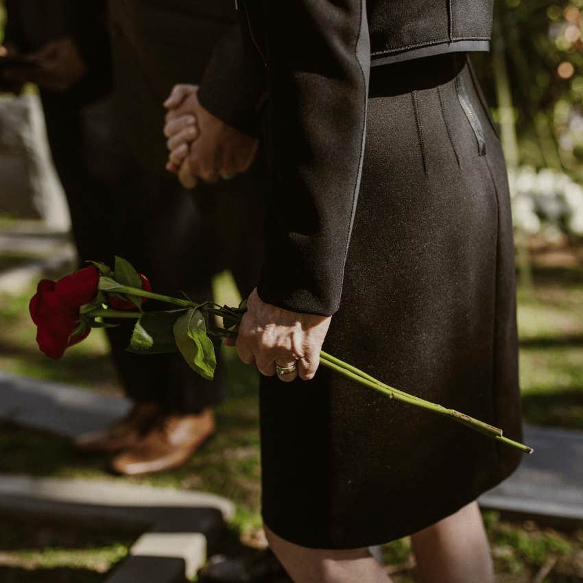 woman in a black dress attending a funeral