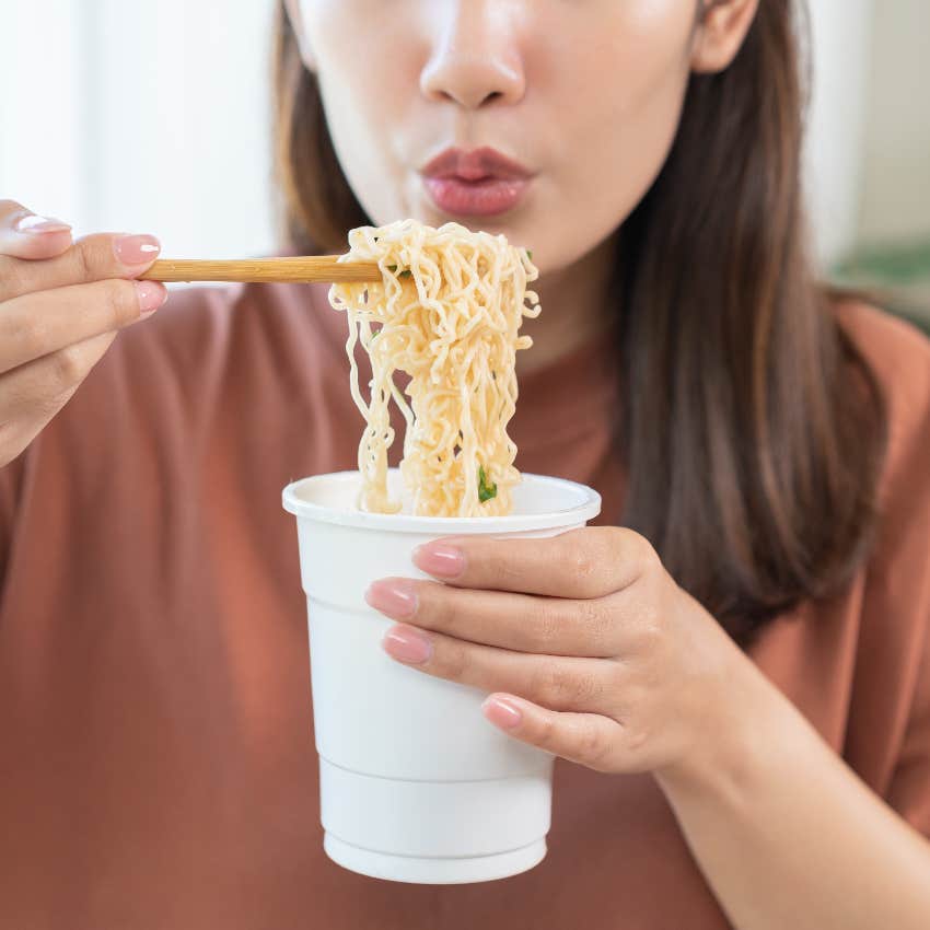 Woman eating instant ramen noodles