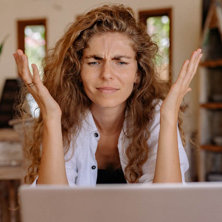 Woman looking frustrated looking at first class ticket prices.