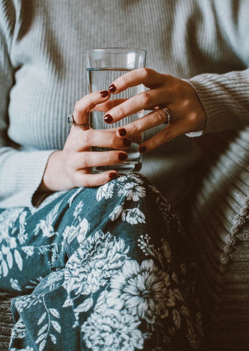 woman holding a glass of water