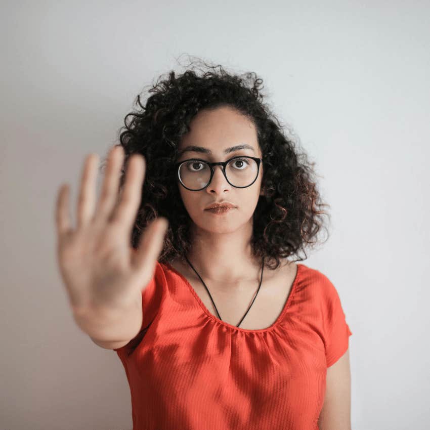 woman holding her hand up in a stop gesture