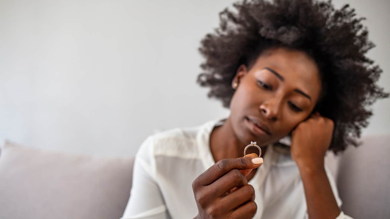 close up shot of woman looking at engagement ring