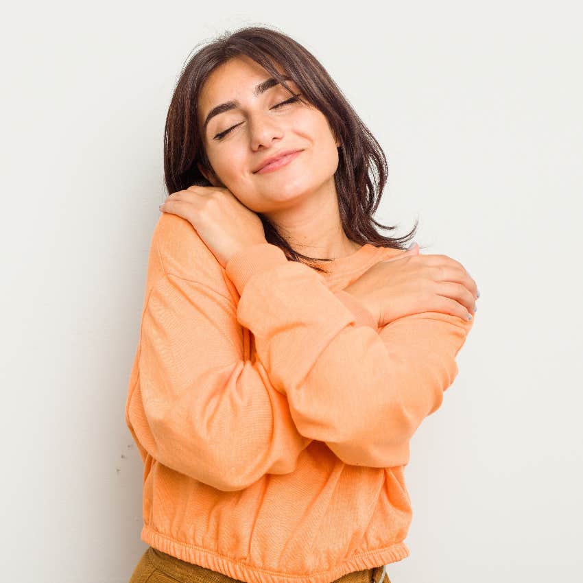 Woman hugging herself