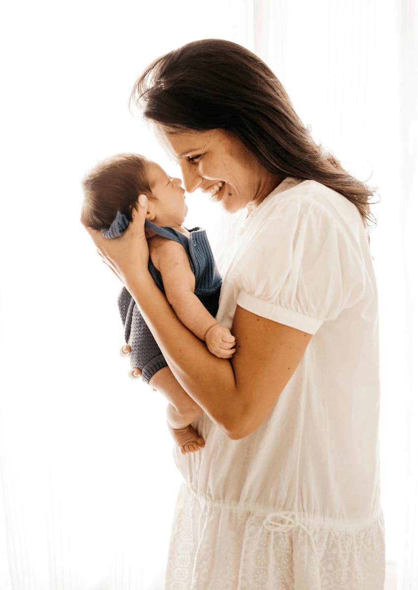 woman smiling newborn baby