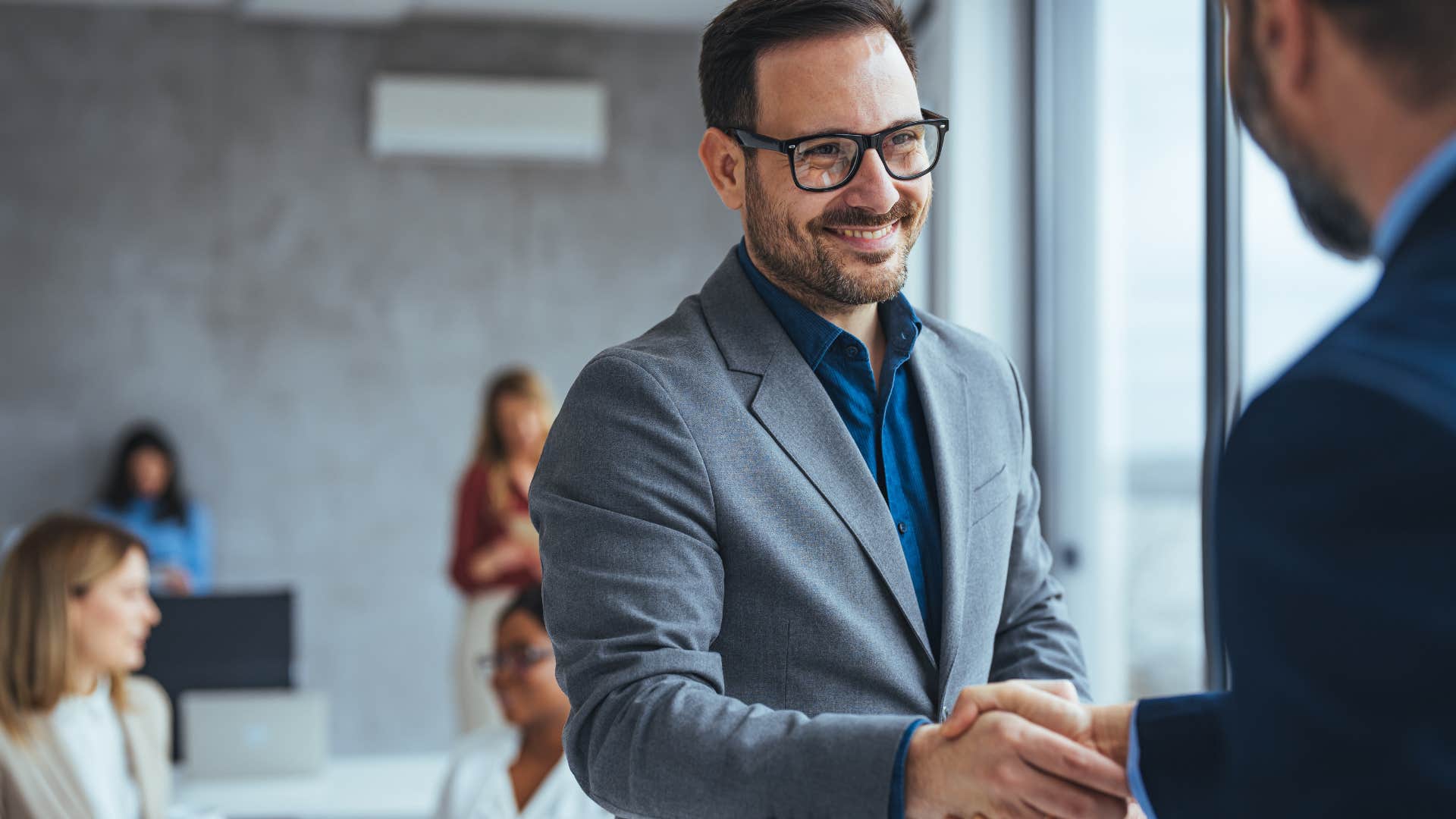 Man looking engaged while shaking hands