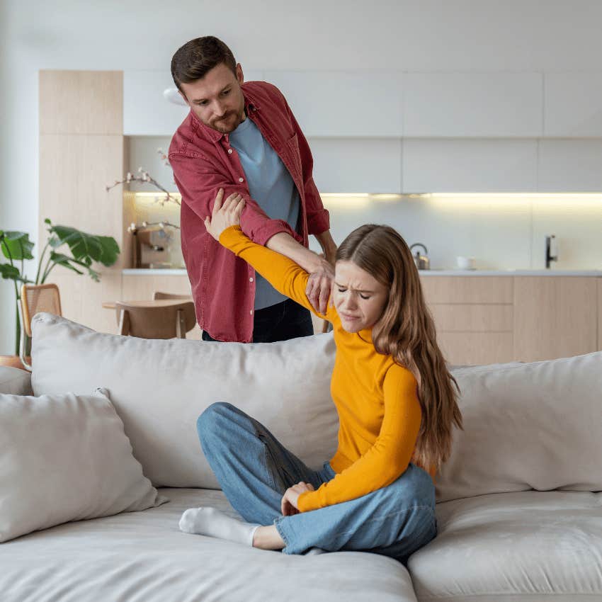 woman trying to push man away from her