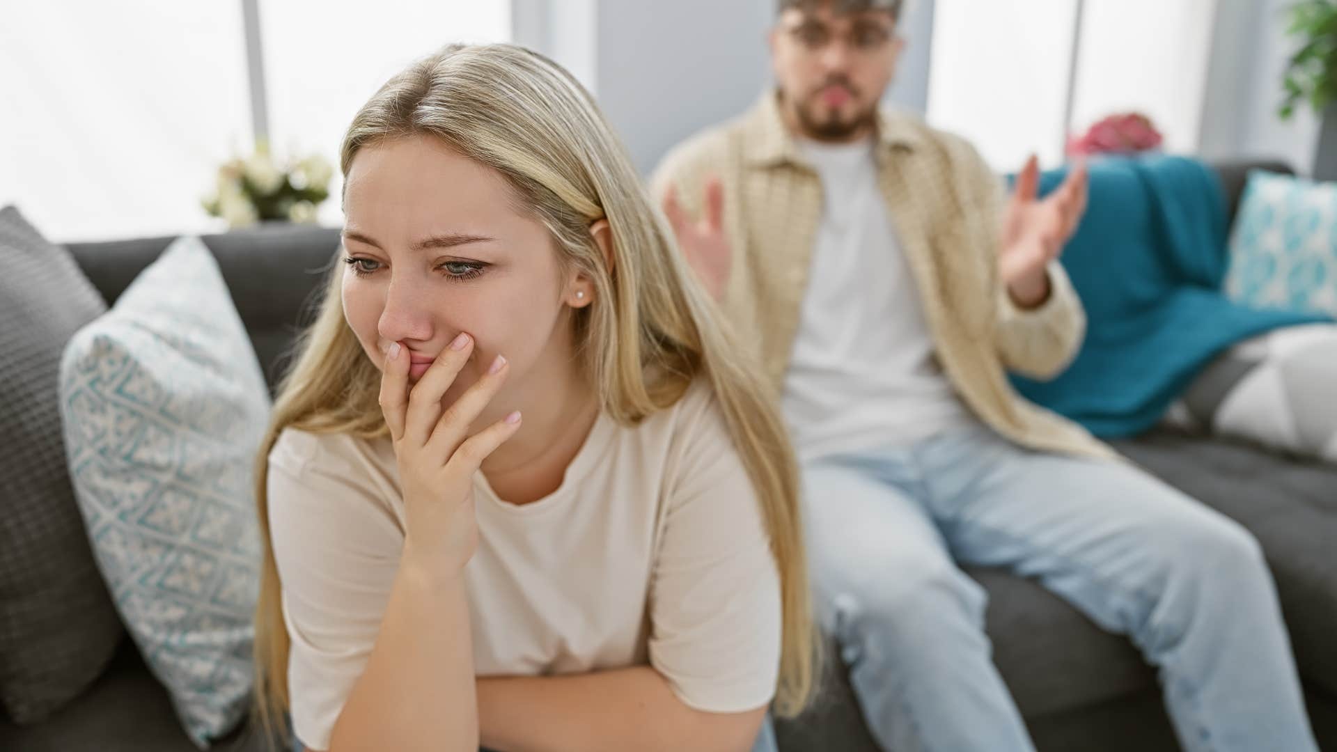 Woman upset sitting in front of her boyfriend. 