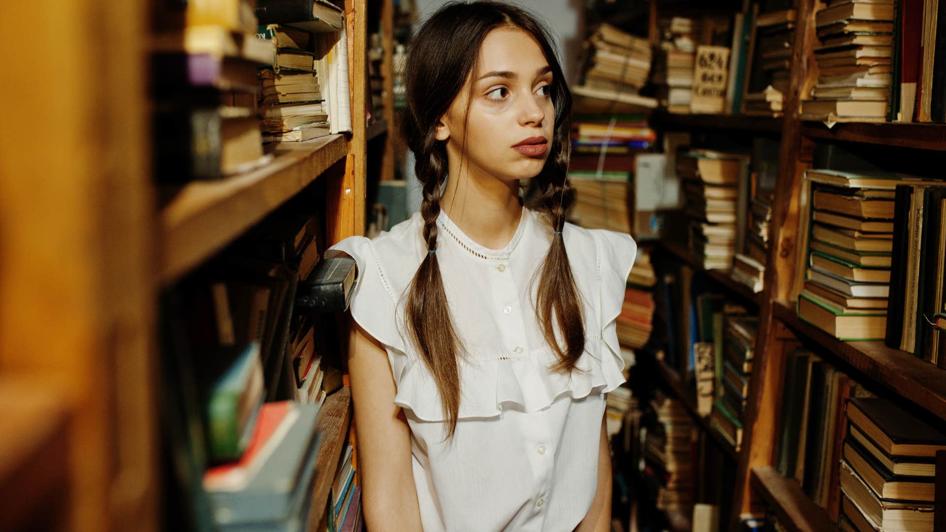 Woman walking through a library.