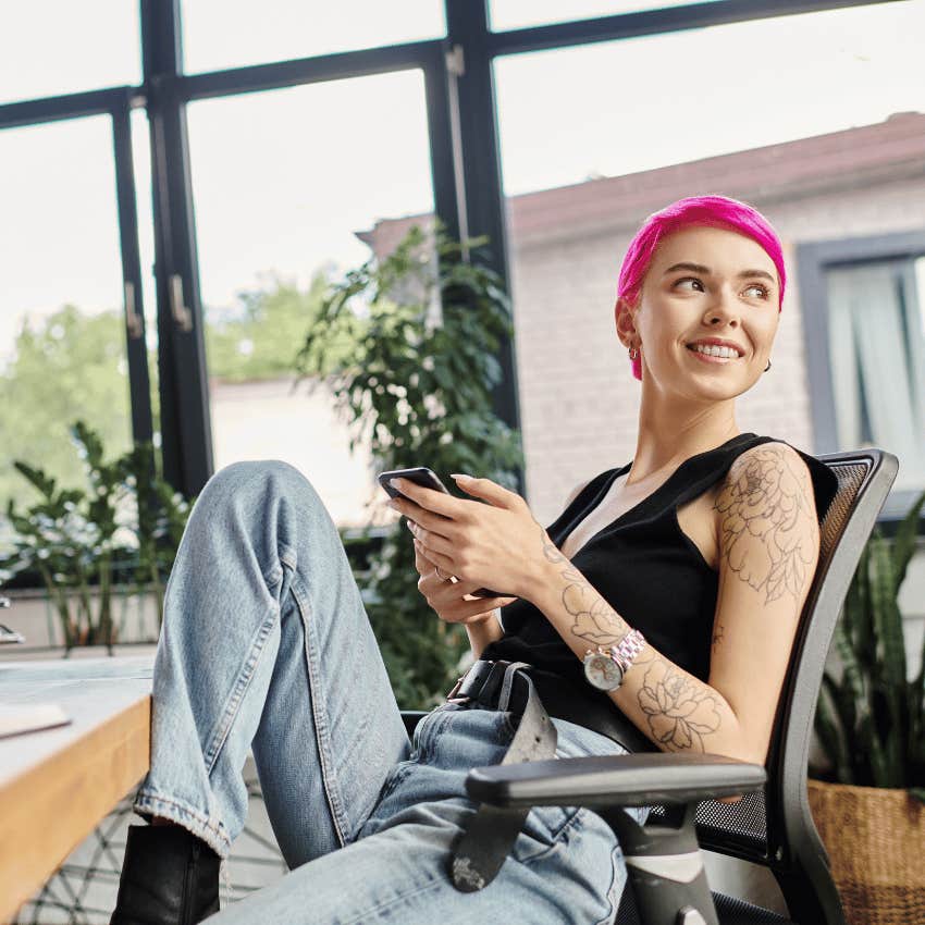 woman with pink hair smiling