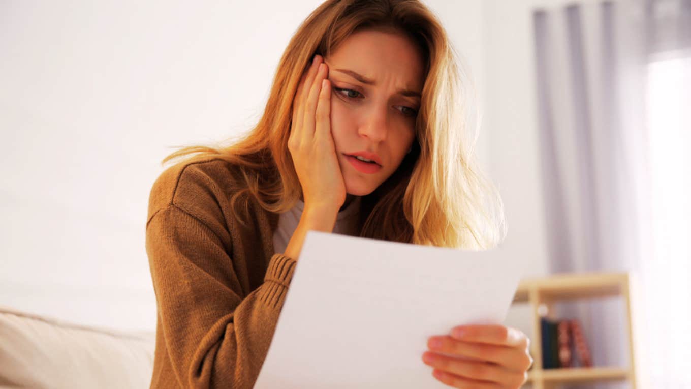 shocked woman reading letter 