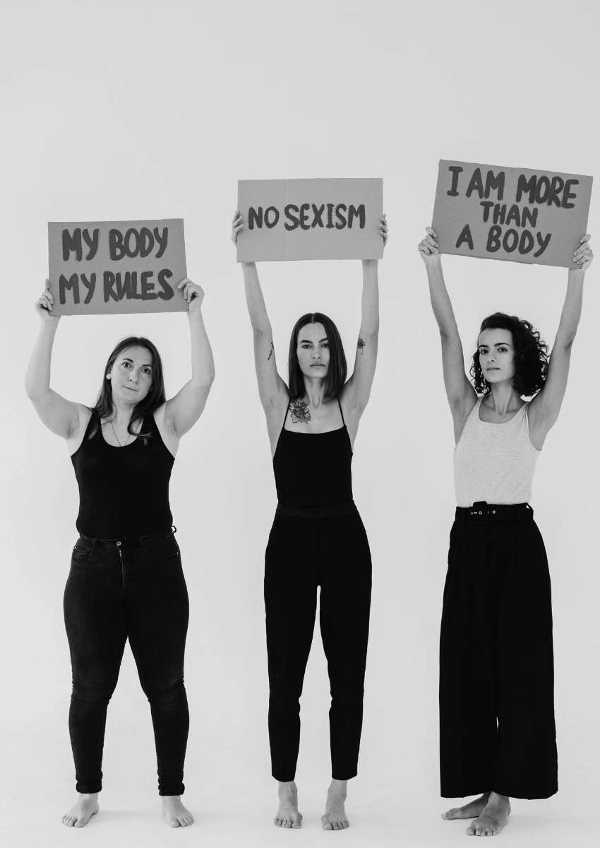 women holding up signs