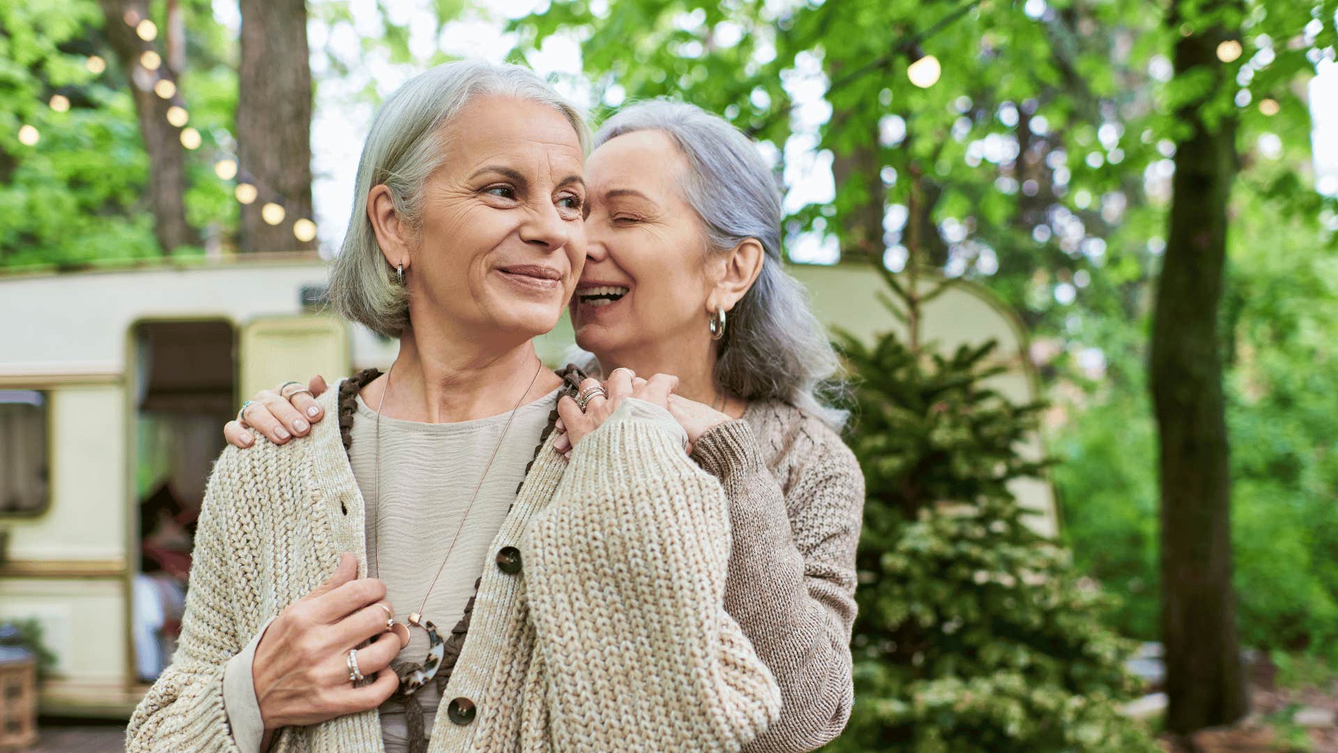 Couple embraces closely, look content and at ease