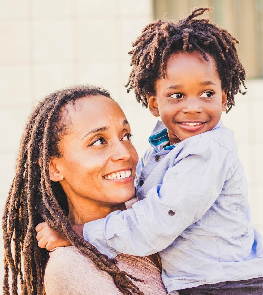 She looks lovingly at child she holds