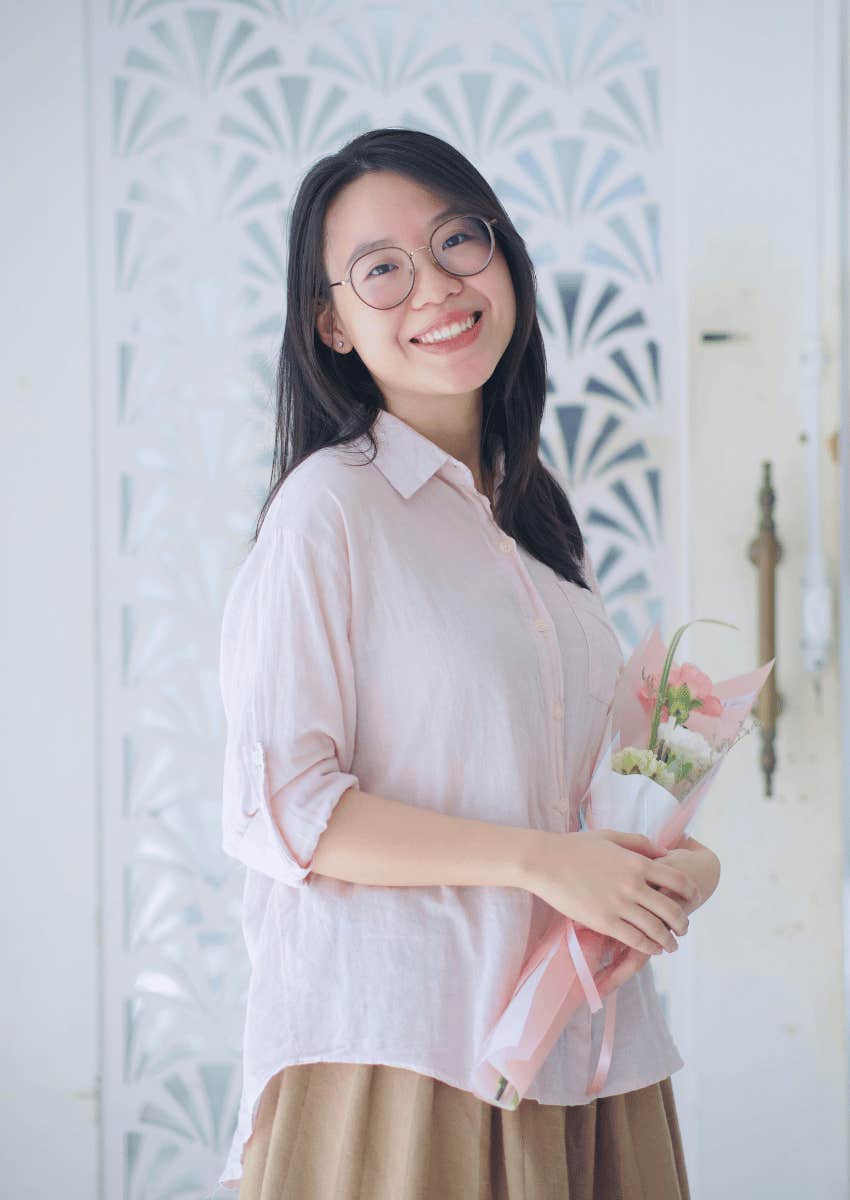 young asian woman holding flowers