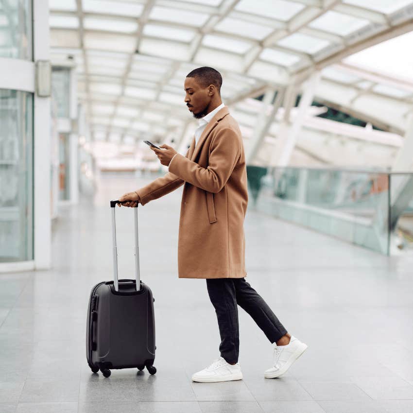 young man walking through airport