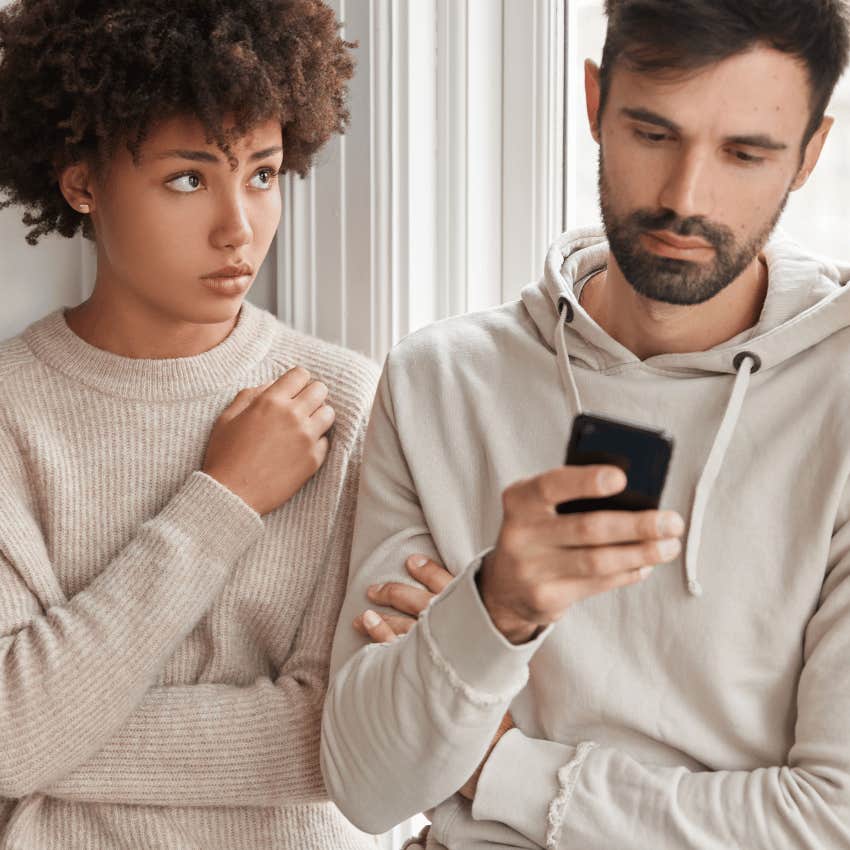 young woman being ignored by man on his phone