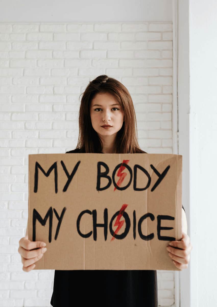 young woman holding a pro-choice sign