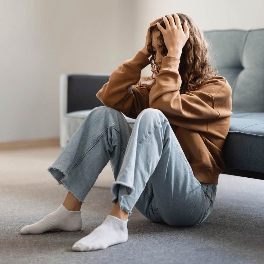 young woman touching her head in despair