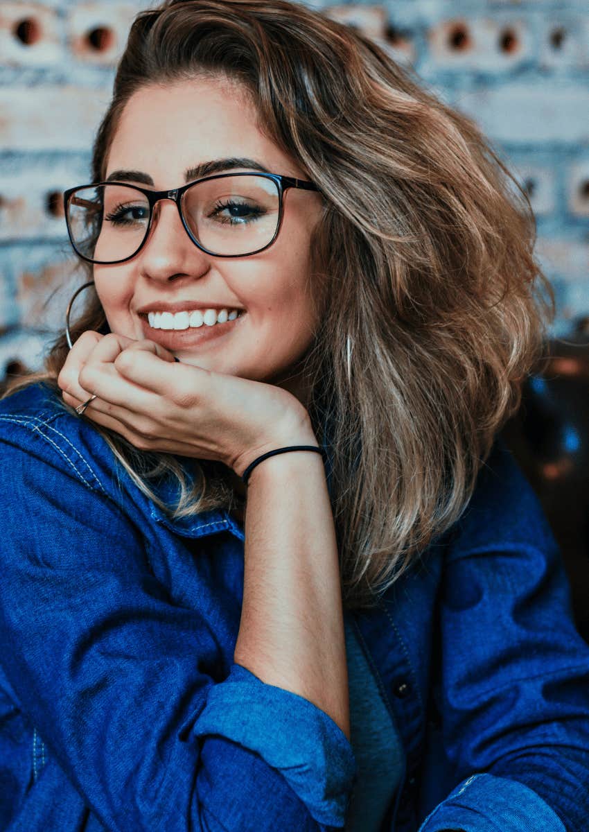 young woman wearing glasses smiling